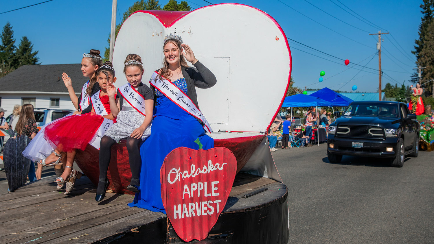 Onalaska Apple Harvest Festival royalty wave from a float along Carlisle Avenue in October 2022.